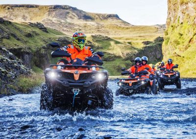 Driving an ATV over a river in Iceland
